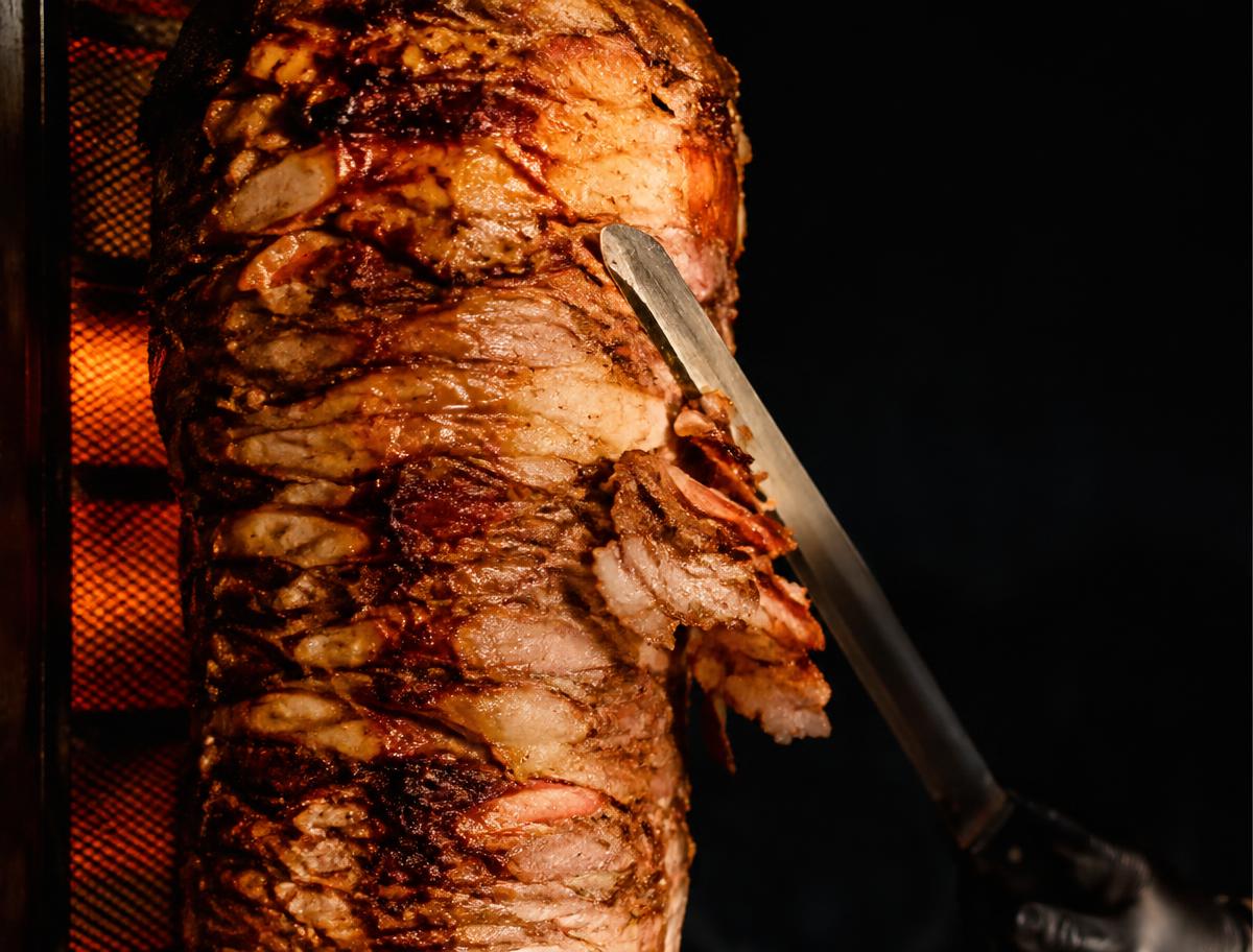 Doner kebab being sliced from the spit